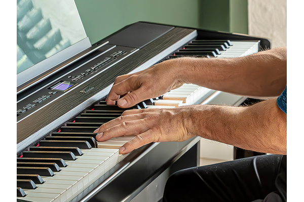 The hands of a person playing the P-525